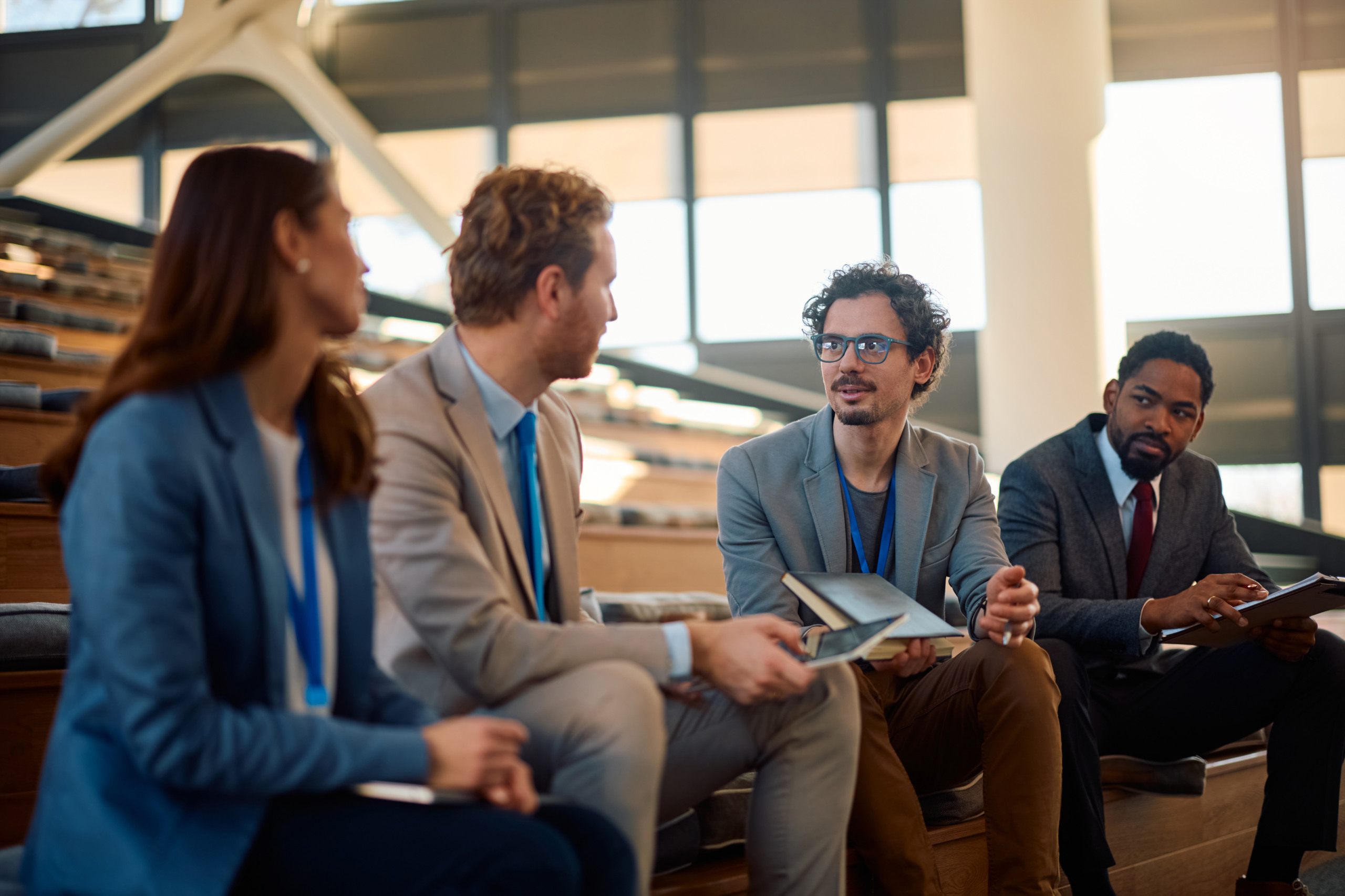 Multiracial group of entrepreneurs talking in a conference hall. PFC PFC - groupe de 4 personnes